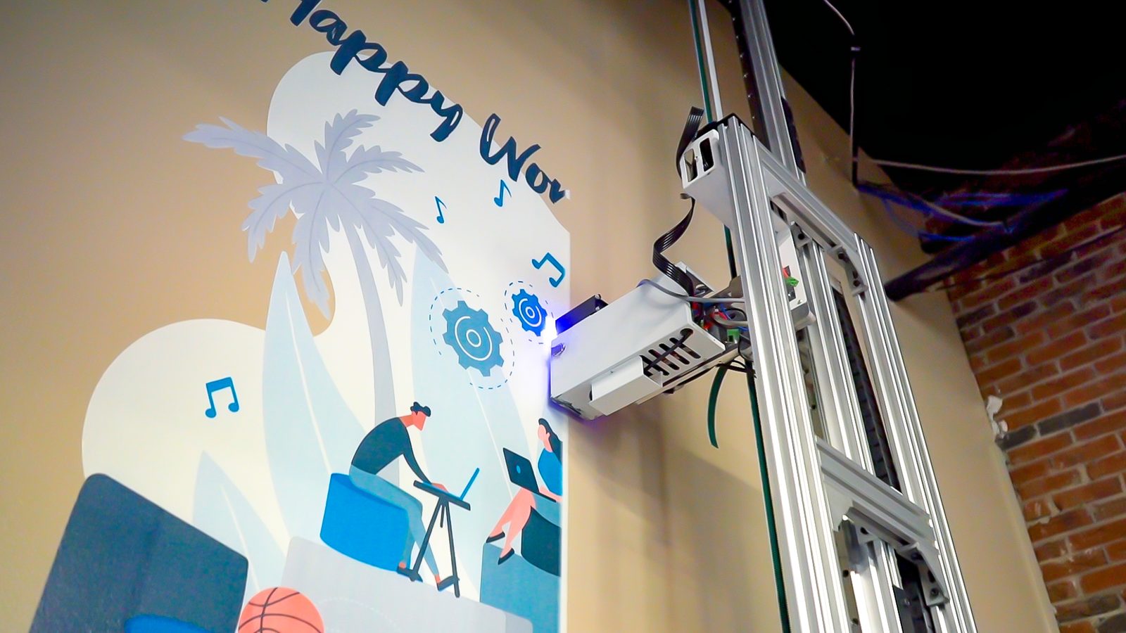 Close-up of the print head applying color directly onto an interior wall